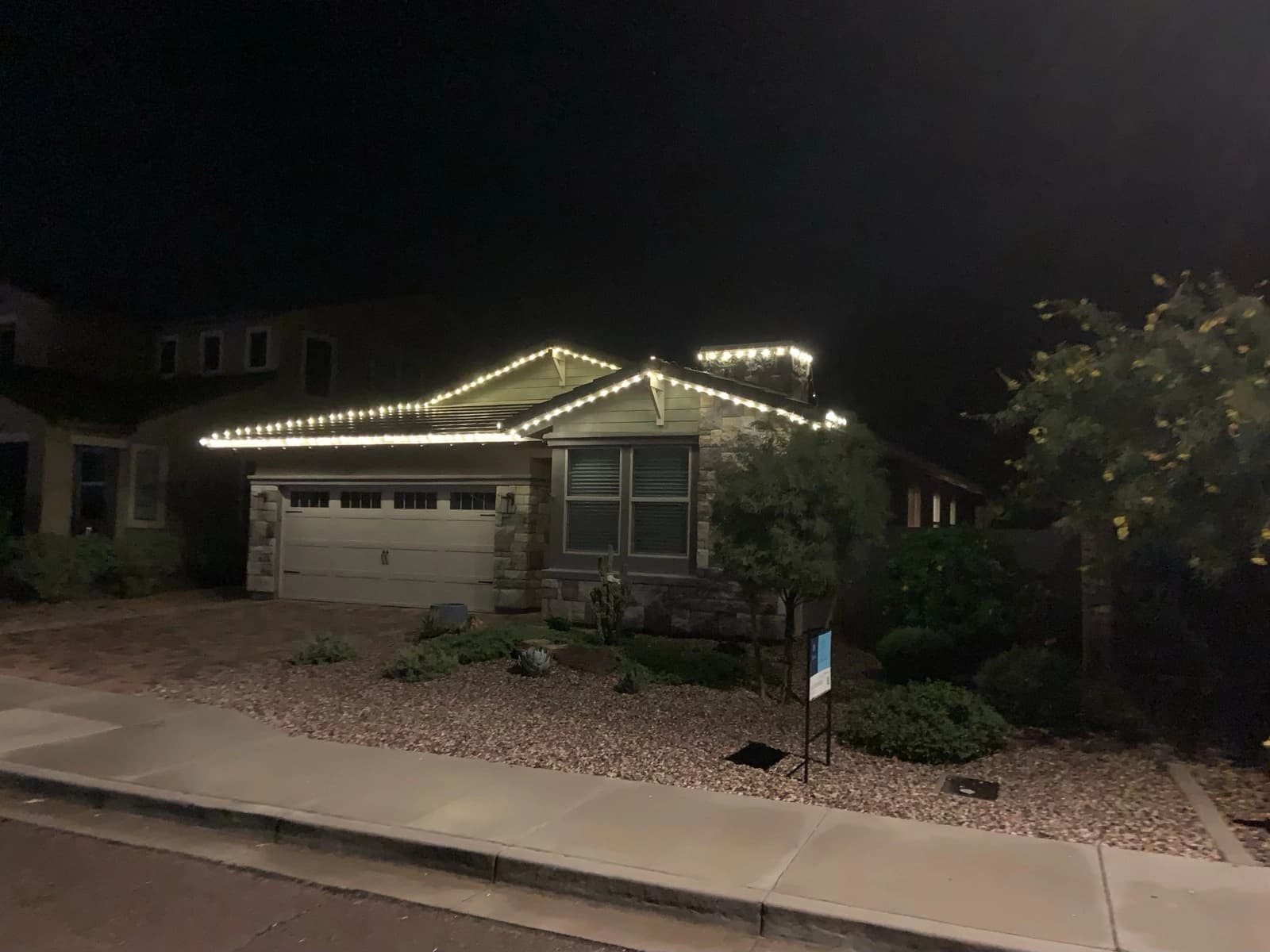 Holiday lighting along the eaves of a Phoenix home