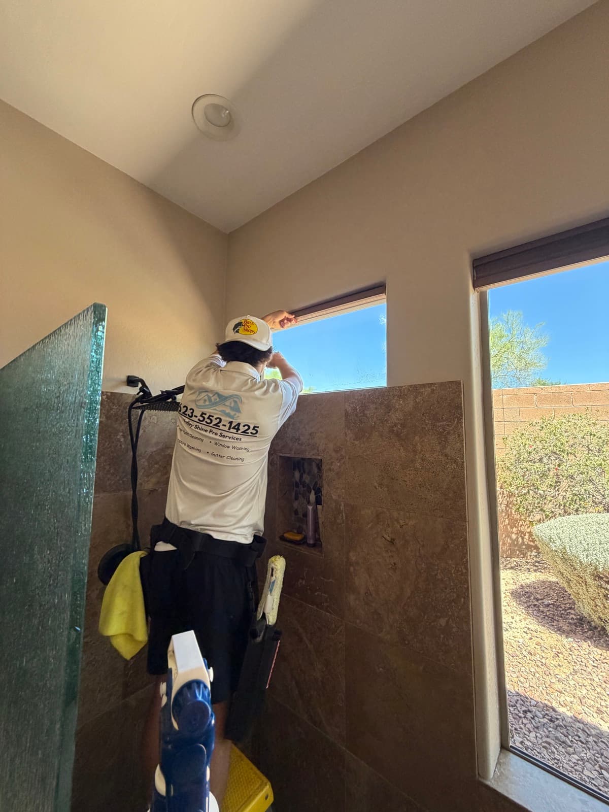 Valley Shine Pro detailing a high window by hand