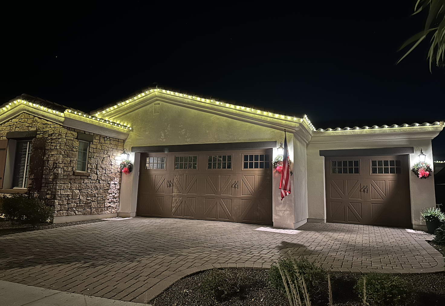 Elegant warm white Christmas lights on luxury stone home