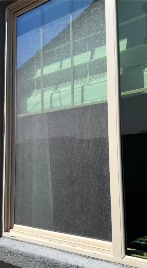 Dirty residential window before professional cleaning showing heavy buildup